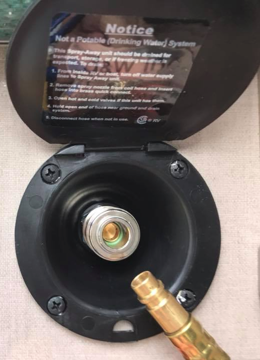 How do I insert/remove the shower hose in the port on the back wall? TOWB